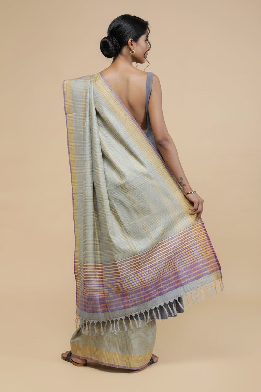 Woman wearing a light-colored Dupatta with colorful stripes on a beige background